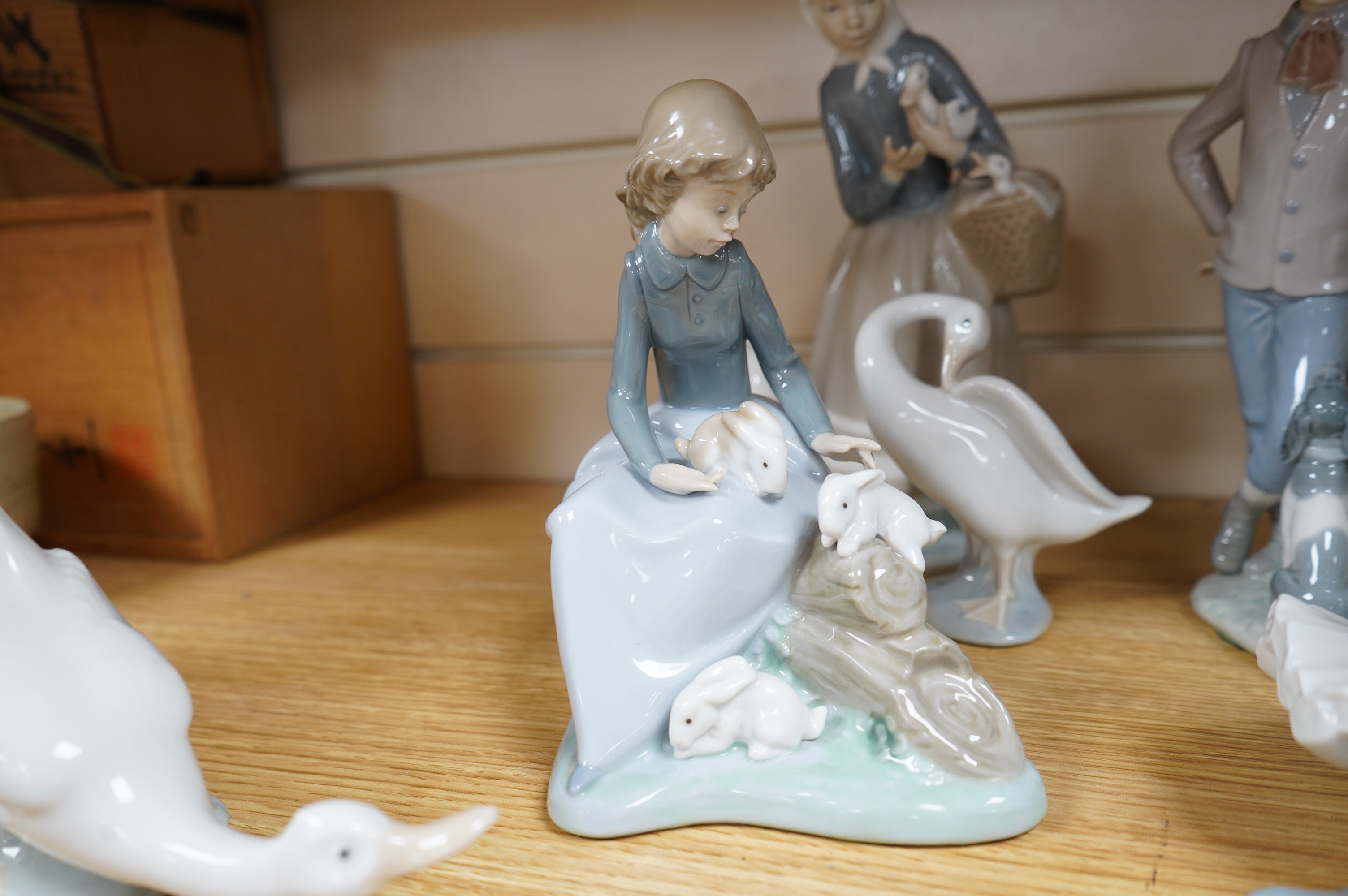 A Royal Doulton figure ‘Promenade’ HN3072, and a group of eight Lladro/Nao figures, largest 33cm high. Condition - good